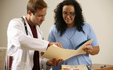 A Doctor and a technician discussing a patient file