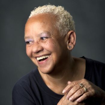 Headshot of Nikki Giovanni smiling and looking to the left of frame