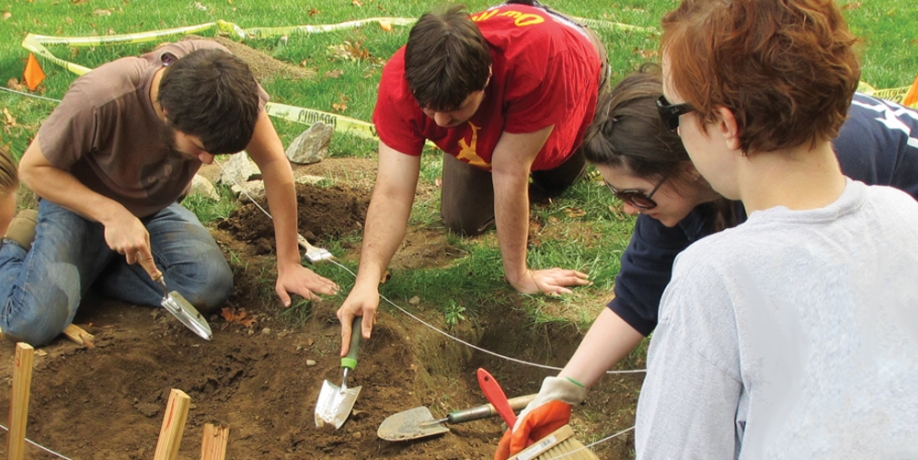 Regis Students digging in dirt