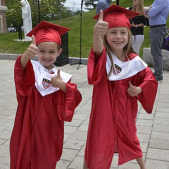 A photo of two Children's Center students in their graduation robes