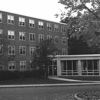 A black and white photo of the entrance to Angela Hall