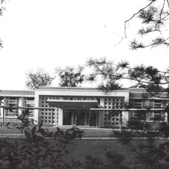 A black and white photo of the entrance to the Regis College Student Center