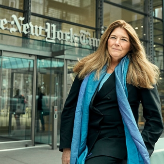 A photo of Carol Giacomo '70 standing in front of the New York Times building