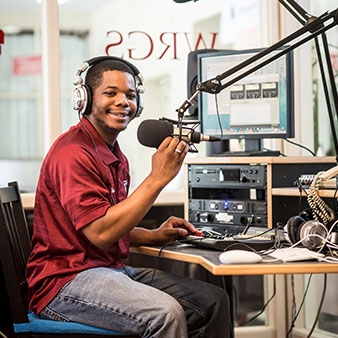 WRGS Radio Station with a student at the mic