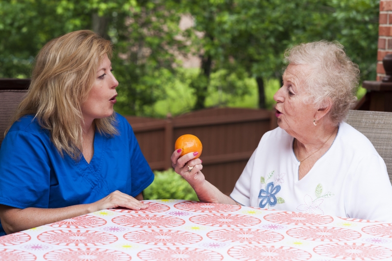 A speech-language pathologist working with a senior citizen