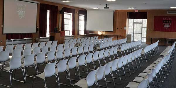 A photo of the Upper Student Center with chairs set up in front of the screen for a presentation