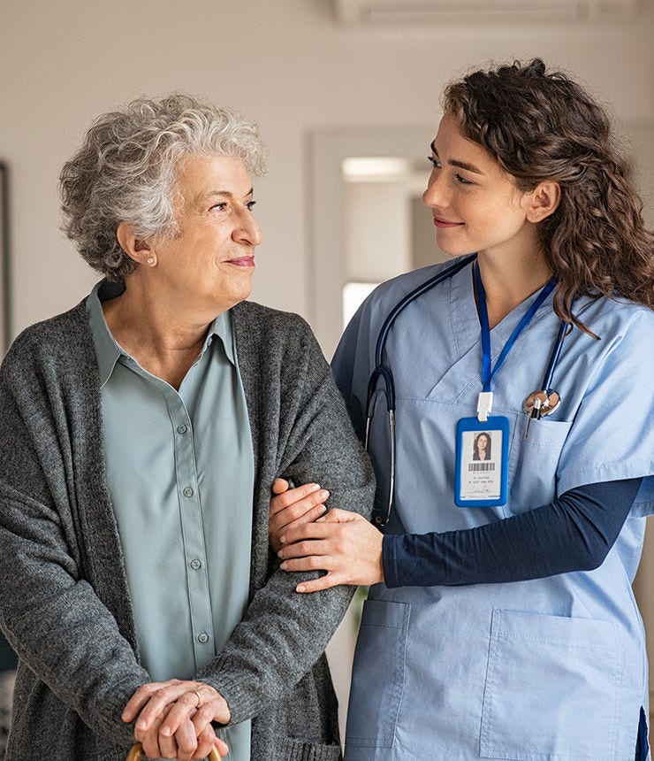 Young caregiver helping senior woman walking. Nurse assisting her old woman patient at nursing home. Senior woman with walking stick being helped by nurse at home.; Shutterstock ID 1910306026; purchase_order: -; job: -; client: -; other: -
