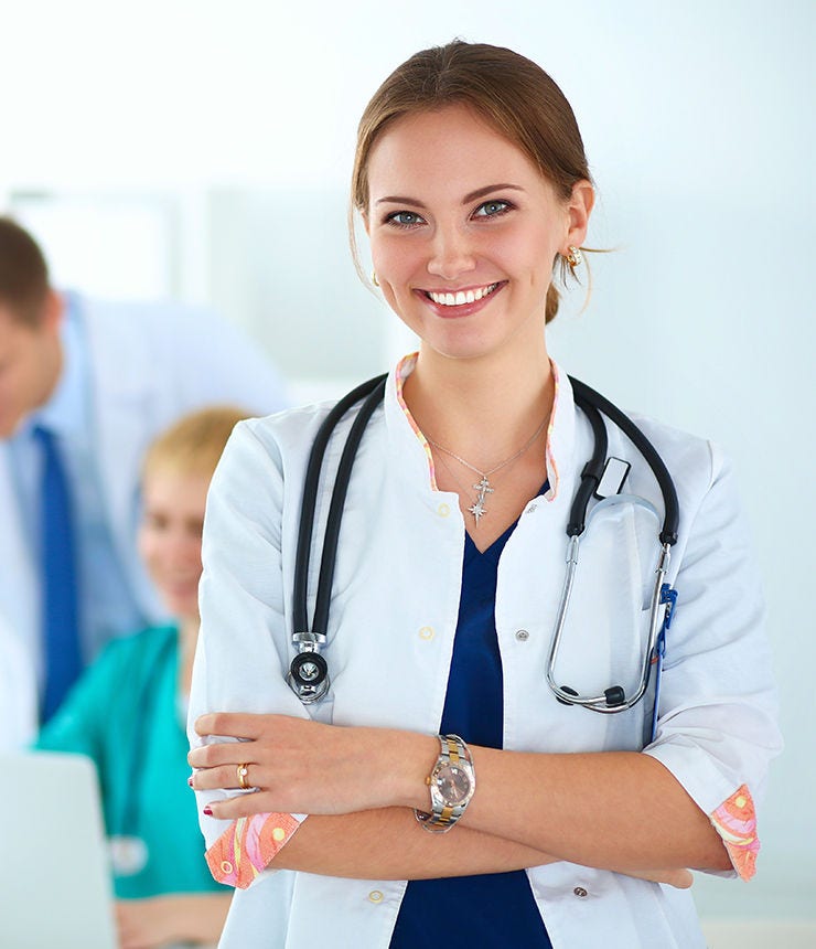 Attractive female doctor in front of medical group; Shutterstock ID 557085679; purchase_order: -; job: -; client: -; other: -