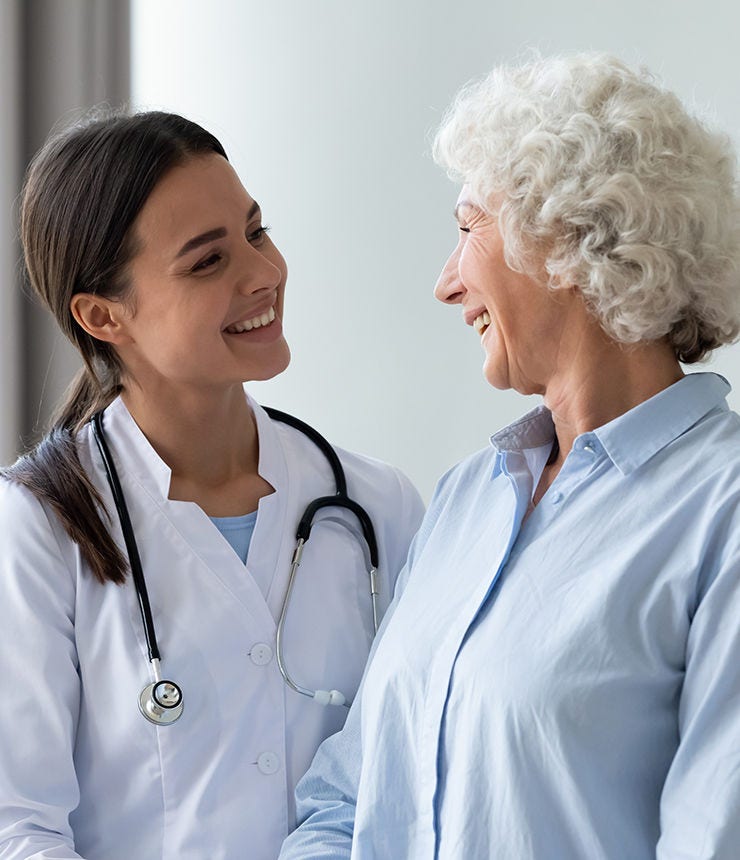 Smiling young female general practitioner enjoying sincere talk, sharing good health news with hoary older senior woman indoors. Caring millennial nurse helping middle aged patient at meeting.; Shutterstock ID 1796733073; purchase_order: -; job: -; client: -; other: -