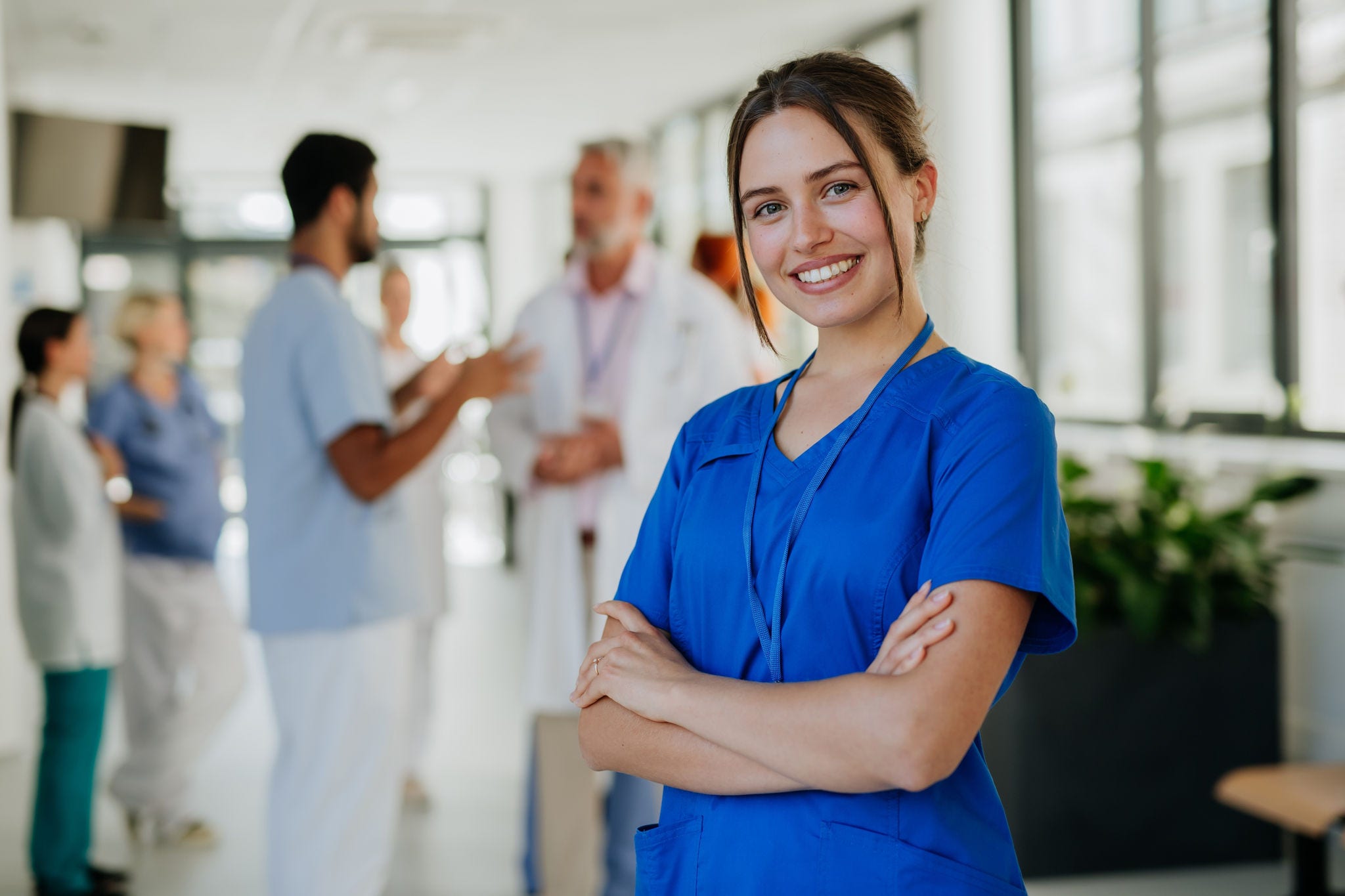 Portrait of young woman nurse at hospital corridor.; Shutterstock ID 2237105521; purchase_order: -; job: -; client: -; other: -