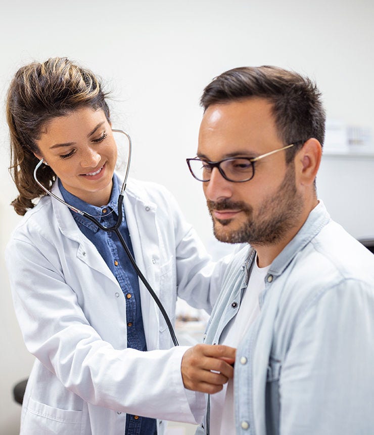 Young doctor is using a stethoscope listen to the heartbeat of the patient. Shot of a female doctor giving a male patient a check up; Shutterstock ID 2200802261; purchase_order: -; job: -; client: -; other: -