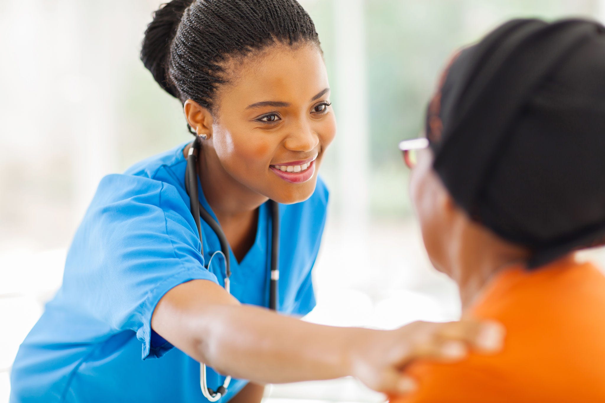 caring african medical nurse comforting senior patient in office; Shutterstock ID 151335629; purchase_order: -; job: -; client: -; other: -