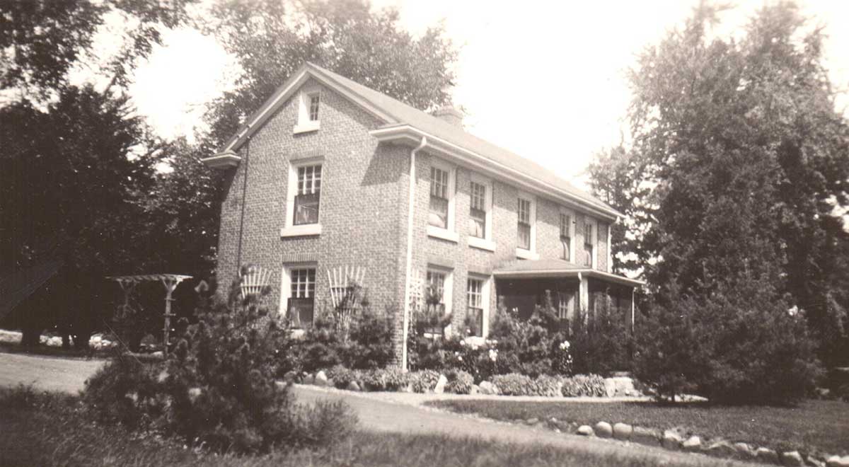 A black and white photo of the original caretaker's house
