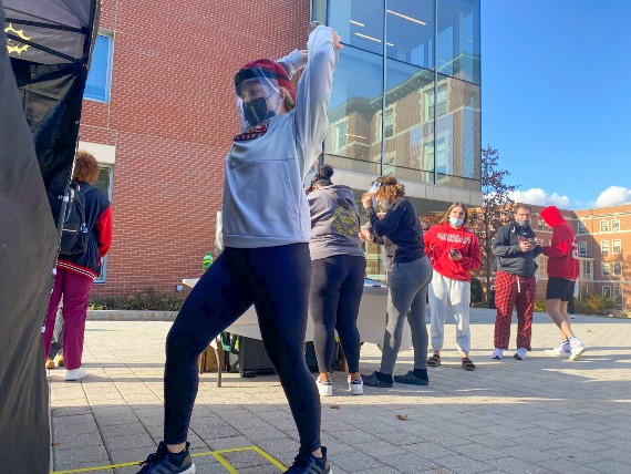 A student stretches before stepping into a mobile smash room