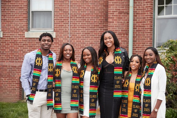 Students pose after receiving their Kente stoles to wear at commencement
