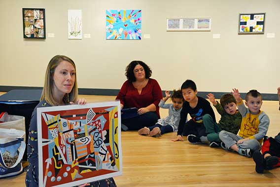Lauren Yockel presents art to students of the Children's Center