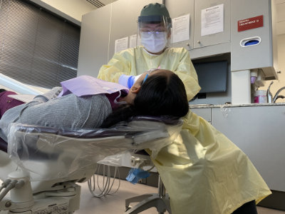 A Dental Hygiene student treats a patient in the Regis College Dental Center