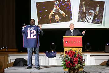 Jack Connors and Andre Tippett auctioning off a Tom Brady signed jersey at the Let It Shine gala.