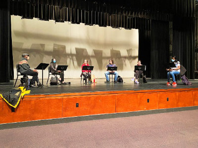 Students on stage during a reading of 'What To The Slave is the Fourth of July'