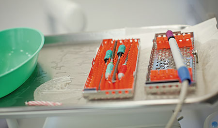 A close-up photo of dental tools sitting on a tray ready to be used