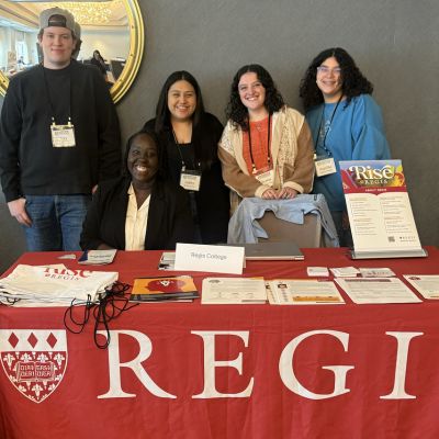 Students and faculty at table
