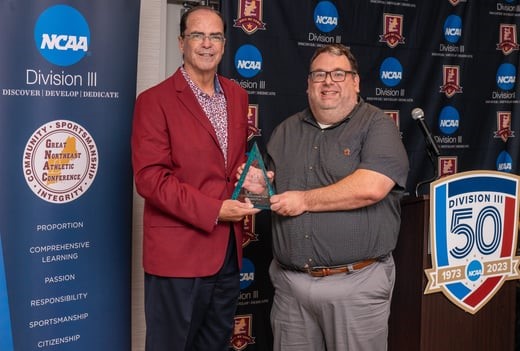 Jason Behenna receiving the 2022-23 GNAC Athletic Communications Staff of the Year Award