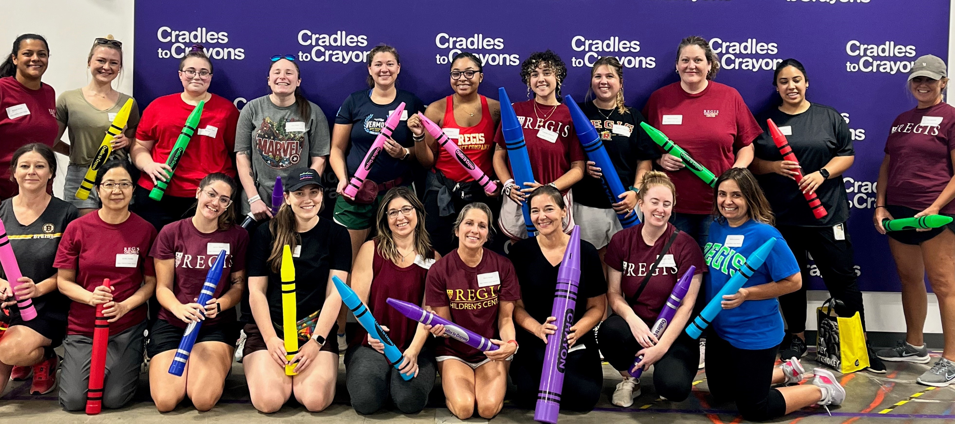 Regis Children's Center and Autism Center staff volunteering at Cradles to Crayons