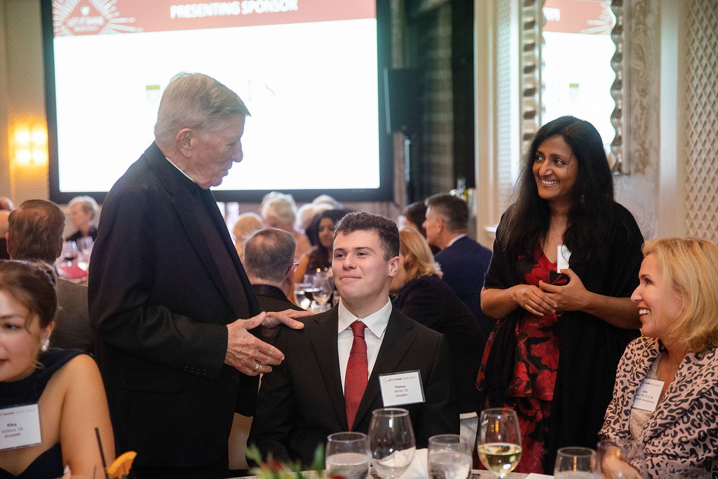 Several gala attendees talking at a table