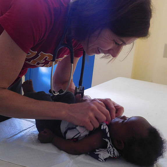 Nurse examining young infant