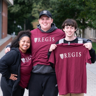 Students pose with their Regis T-shirts