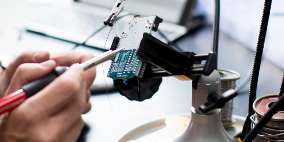 Regis Professor working with biomedical engineering equipment