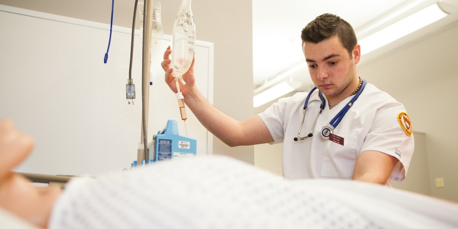 Regis College nursing student in a simulation lab