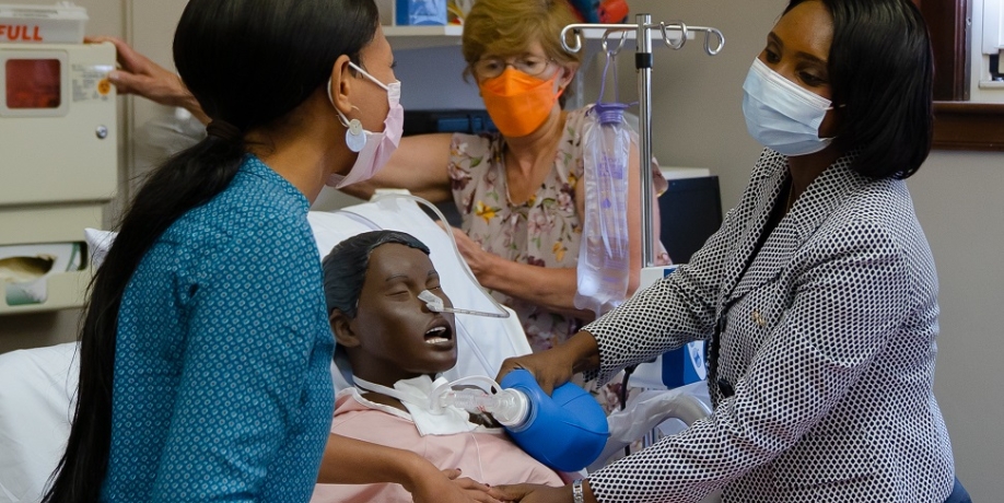 Regis College nursing students in a simulation lab