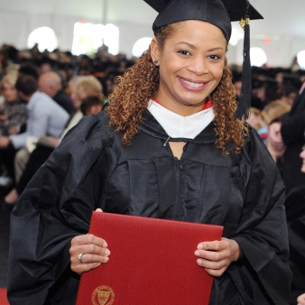 Regis North student holding up her diploma 