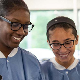 Two medical professionals consult about a patient