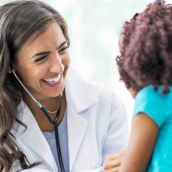 Professional nurse speaking with a young child