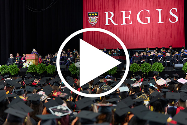 play button over wide shot of commencement. Click here to play video